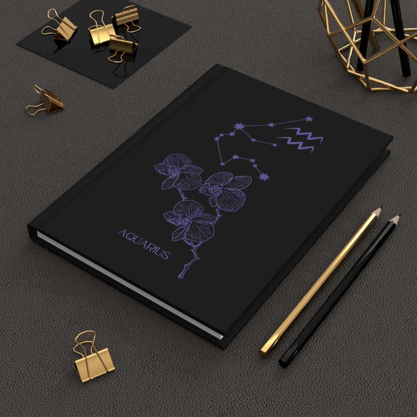 Aquarius black journal with zodiac flower, constellation, and glyph on cover